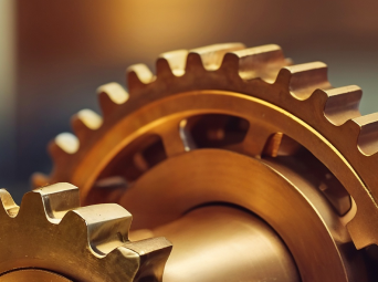 Close-up of interlocking brass gears showing mechanical precision and engineering detail.