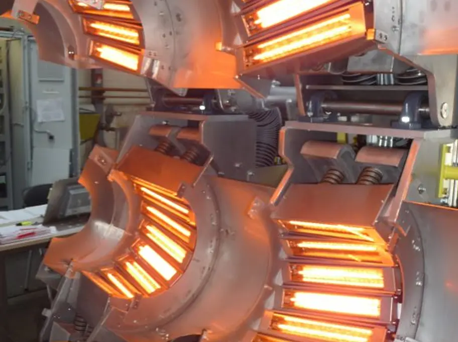 Close-up of cylindrical IR heaters glowing orange