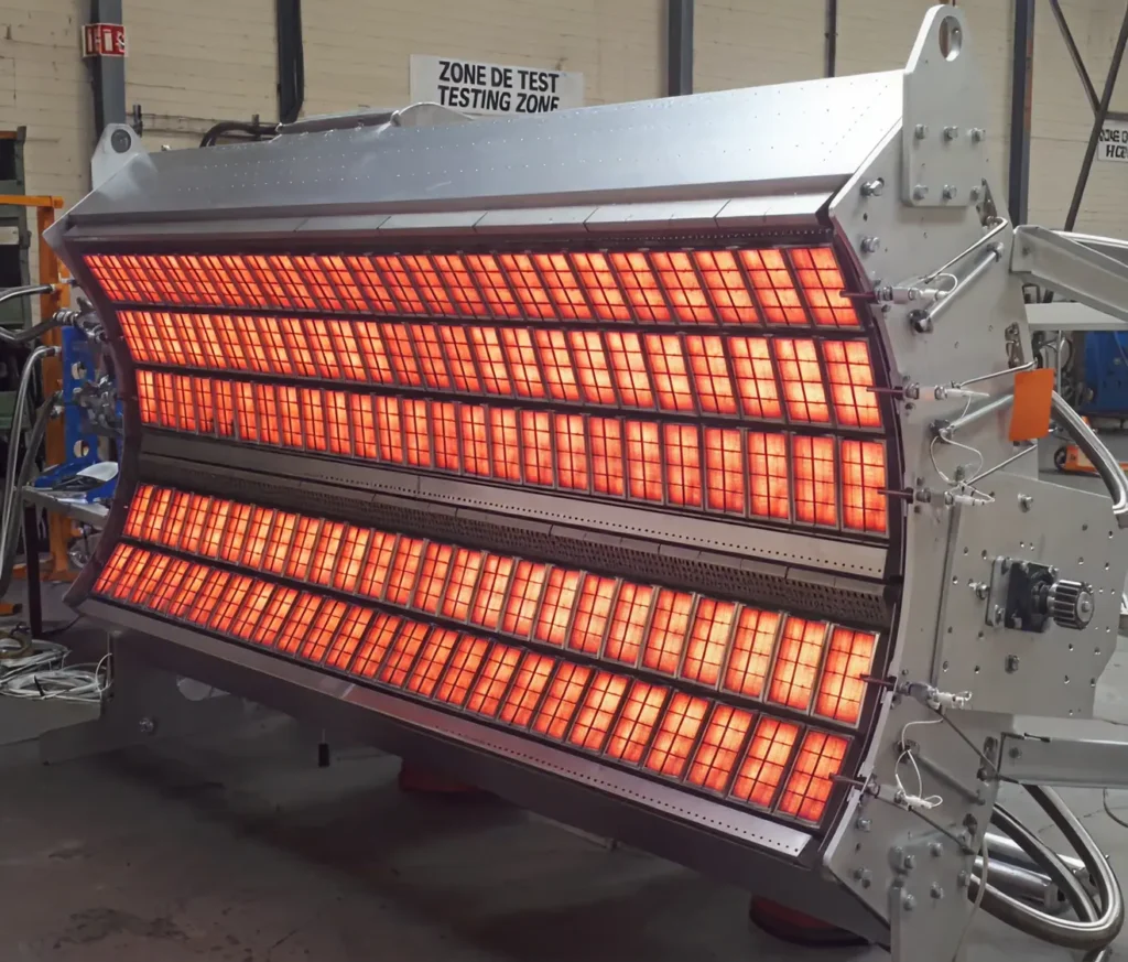 Large curved industrial infrared drying unit glowing red in a testing area.